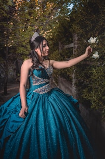 quinceanera posing with flowers. prestige banquet and event center
