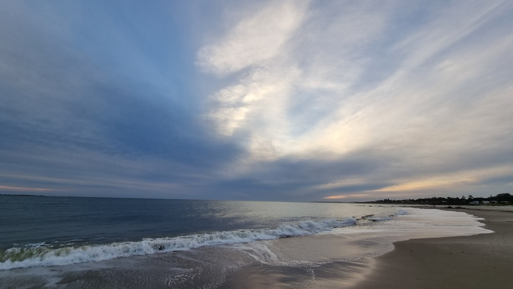 a beach with waves coming in to the shore