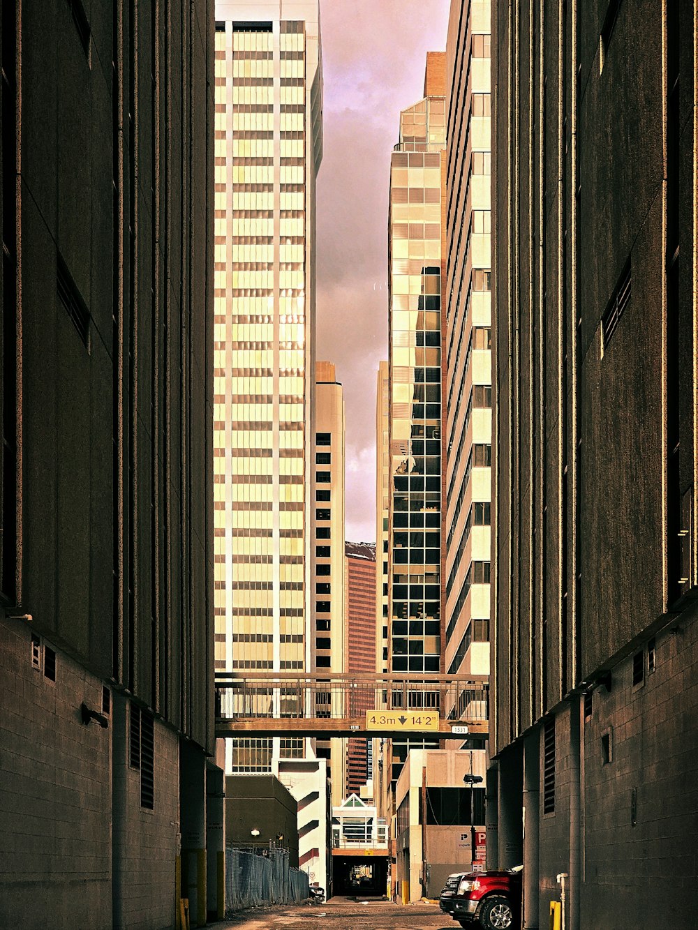 a city street with tall buildings in the background