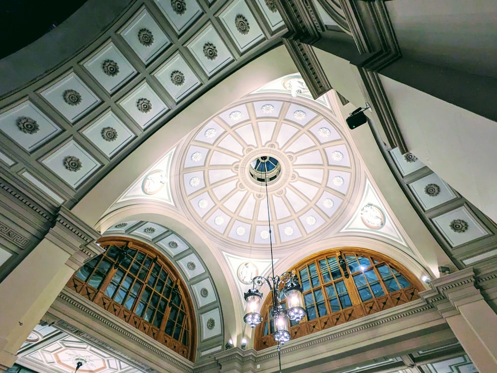 the ceiling of a large building with many windows