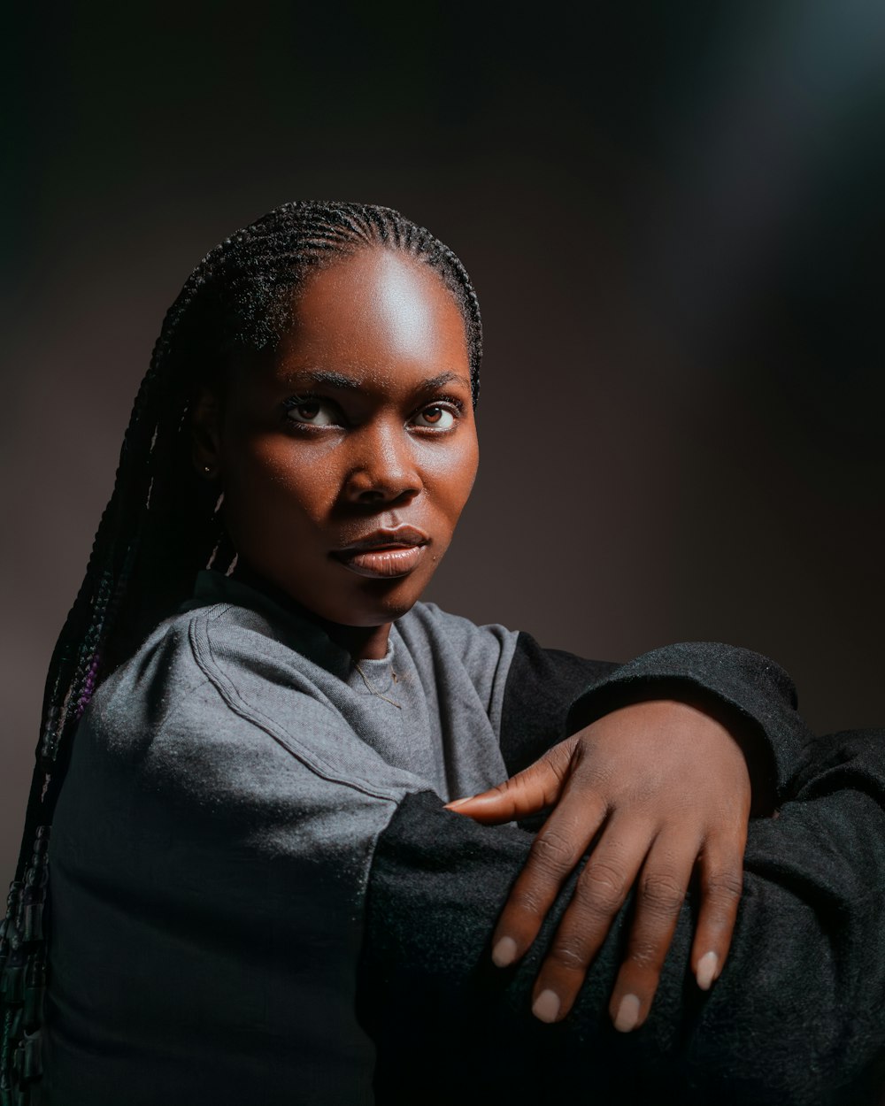 a woman with braids is posing for a picture