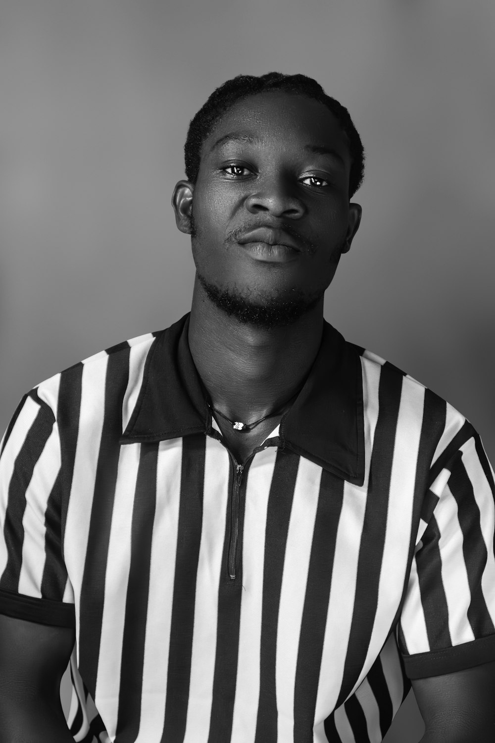 a man in a referee's uniform posing for a picture