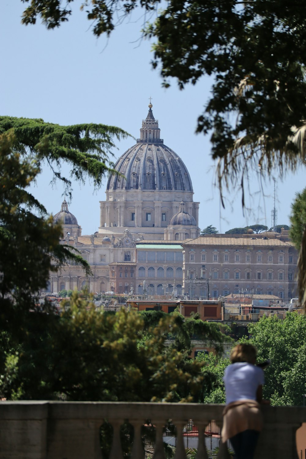 a woman sitting on a bench in front of a building