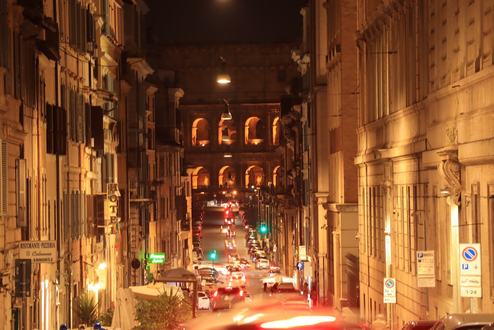 a city street filled with lots of traffic at night