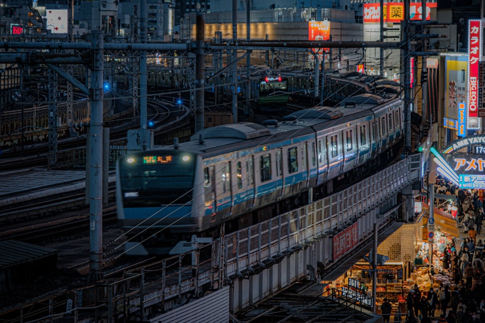 a train traveling through a train station next to tall buildings