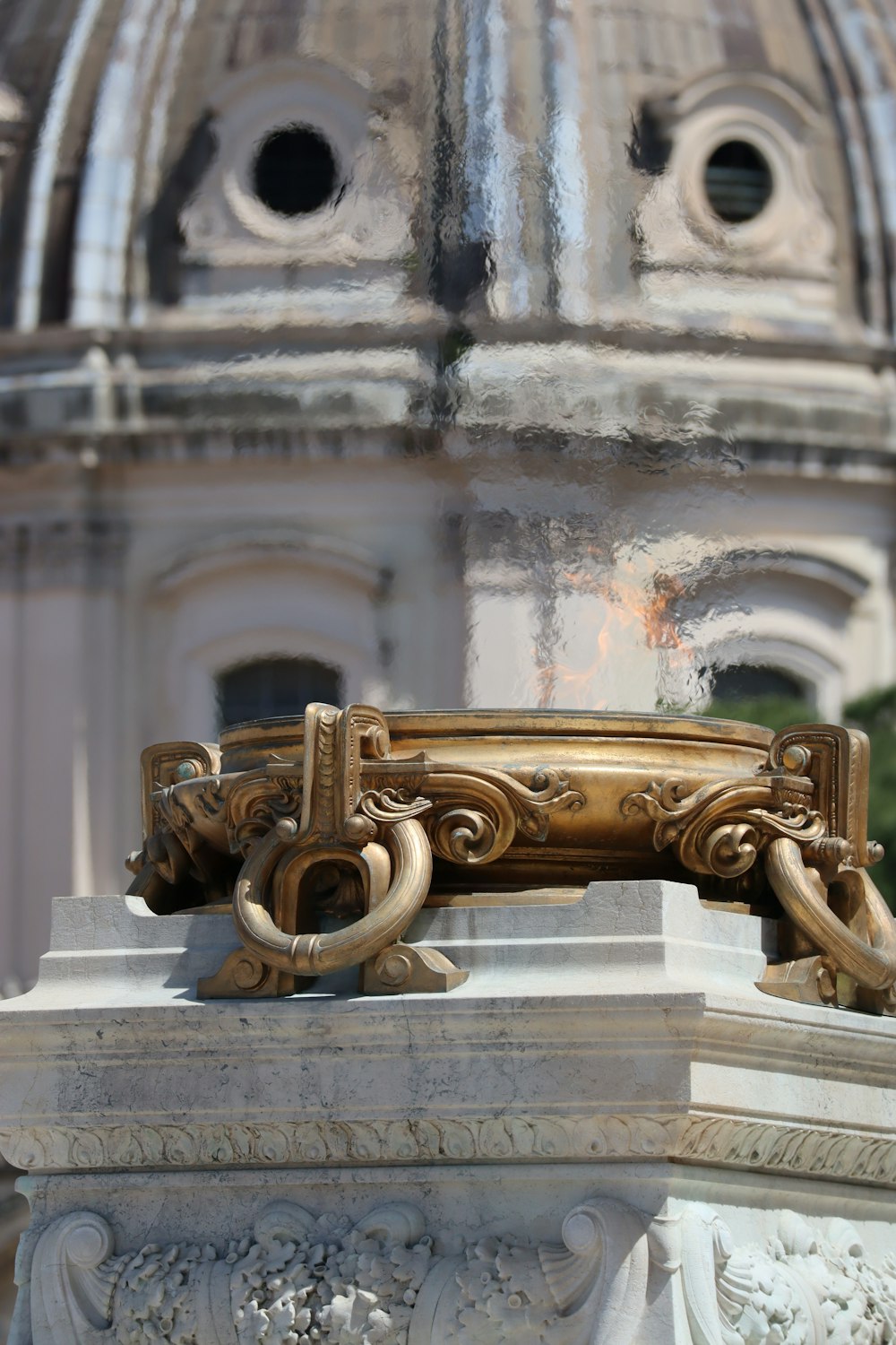 a close up of a statue with a building in the background