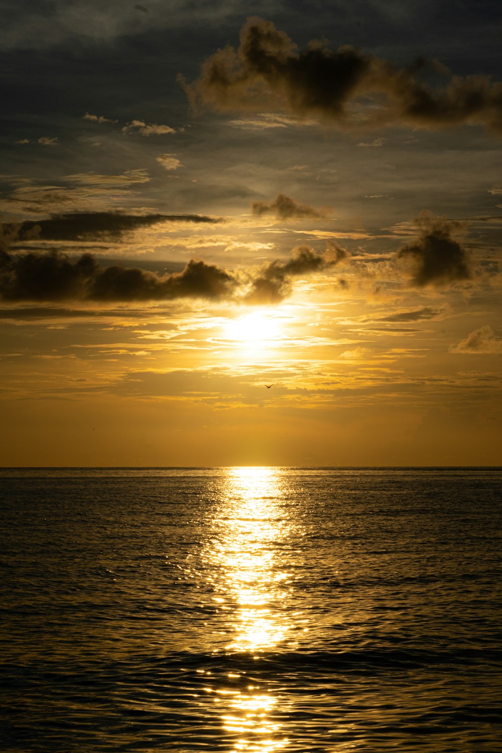 a large body of water under a cloudy sky