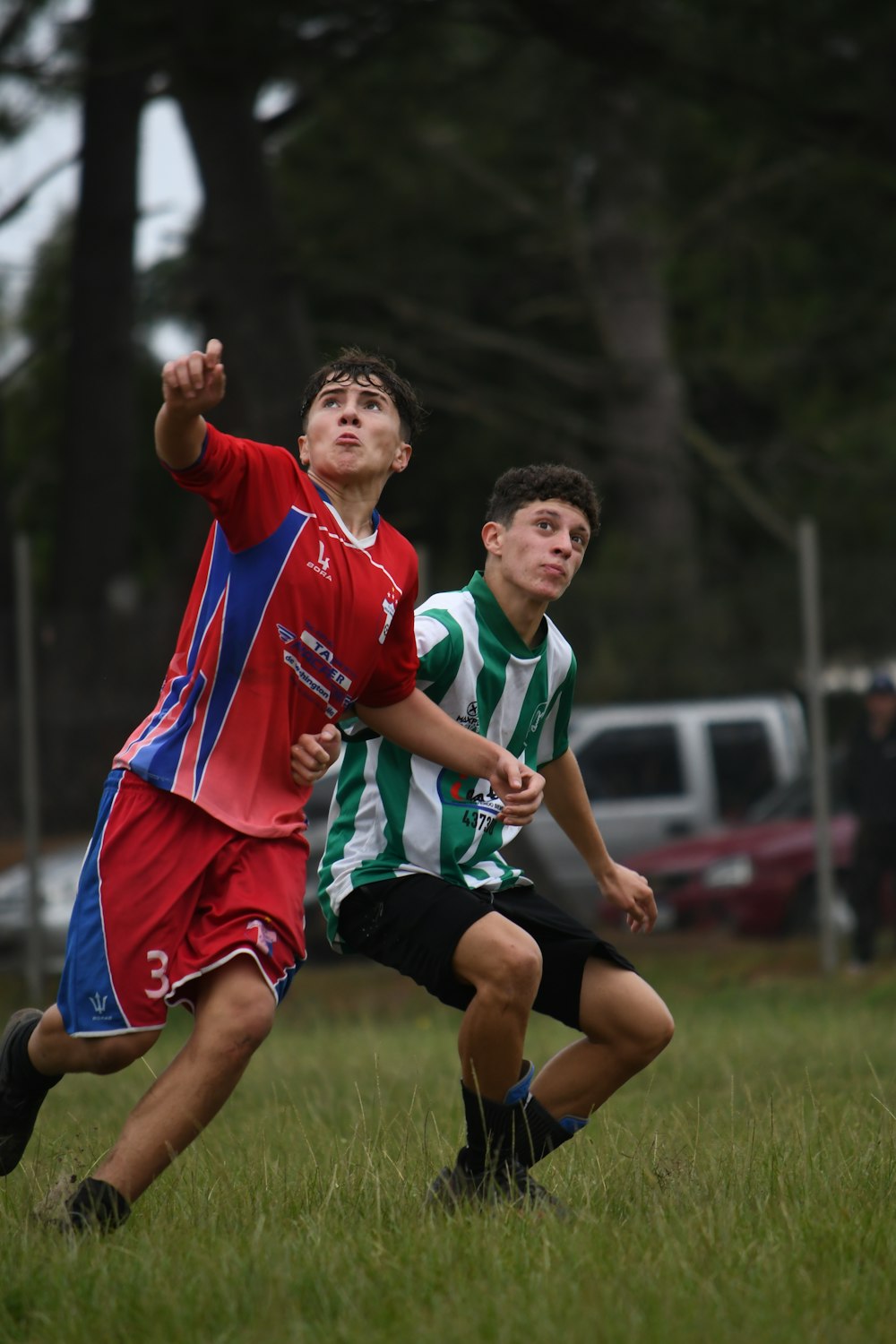 a couple of young men playing a game of soccer