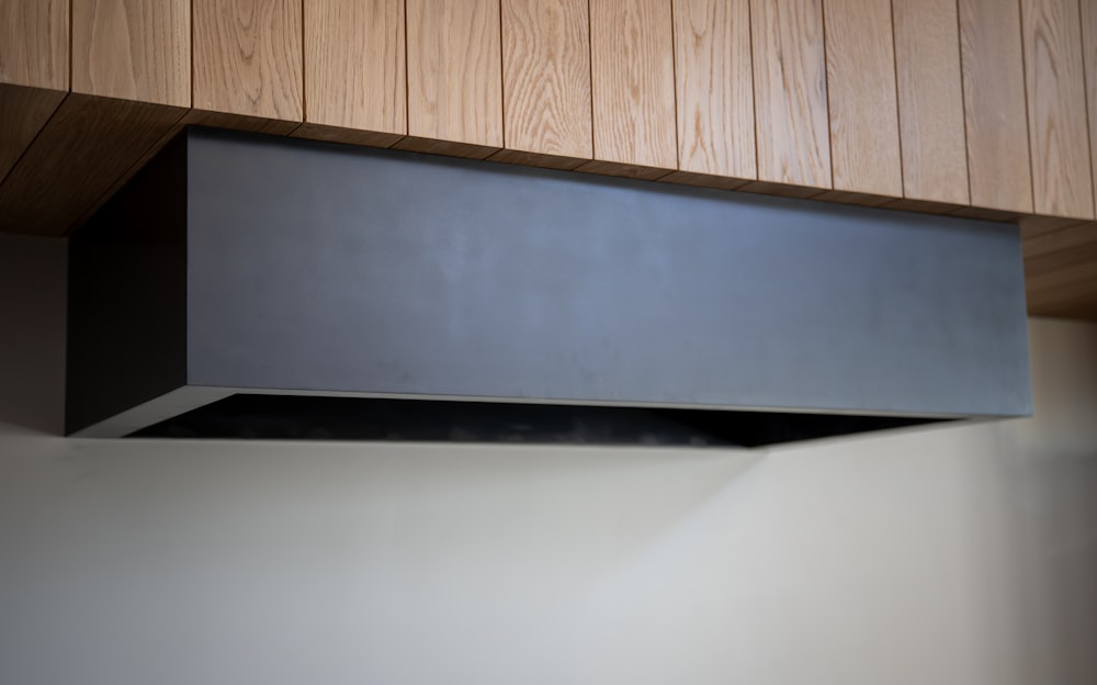 a black stove hood in a kitchen with wood paneling