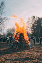 a group of people standing around a fire pit