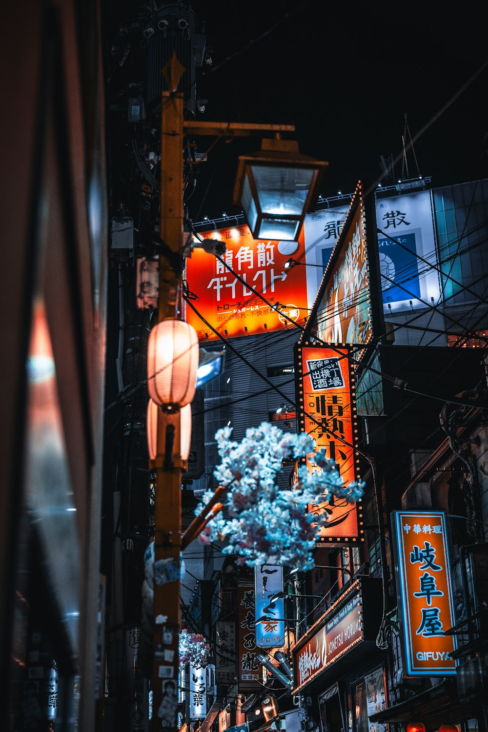 a city street filled with lots of neon signs