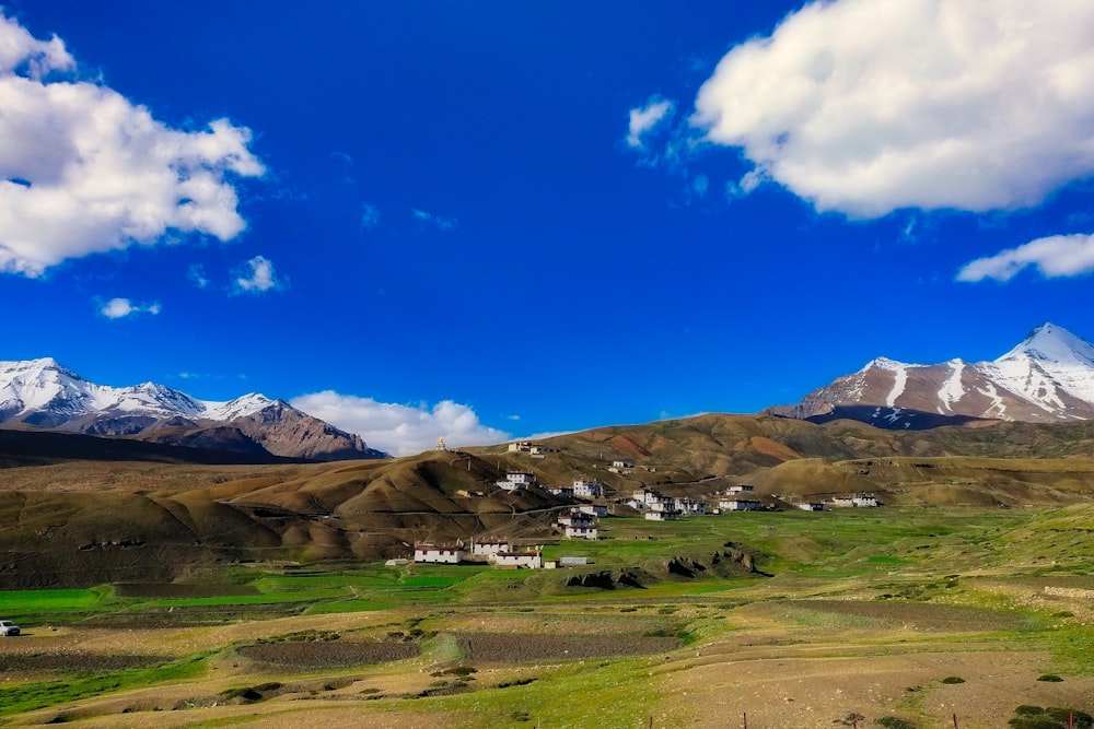 a scenic view of a small village in the mountains