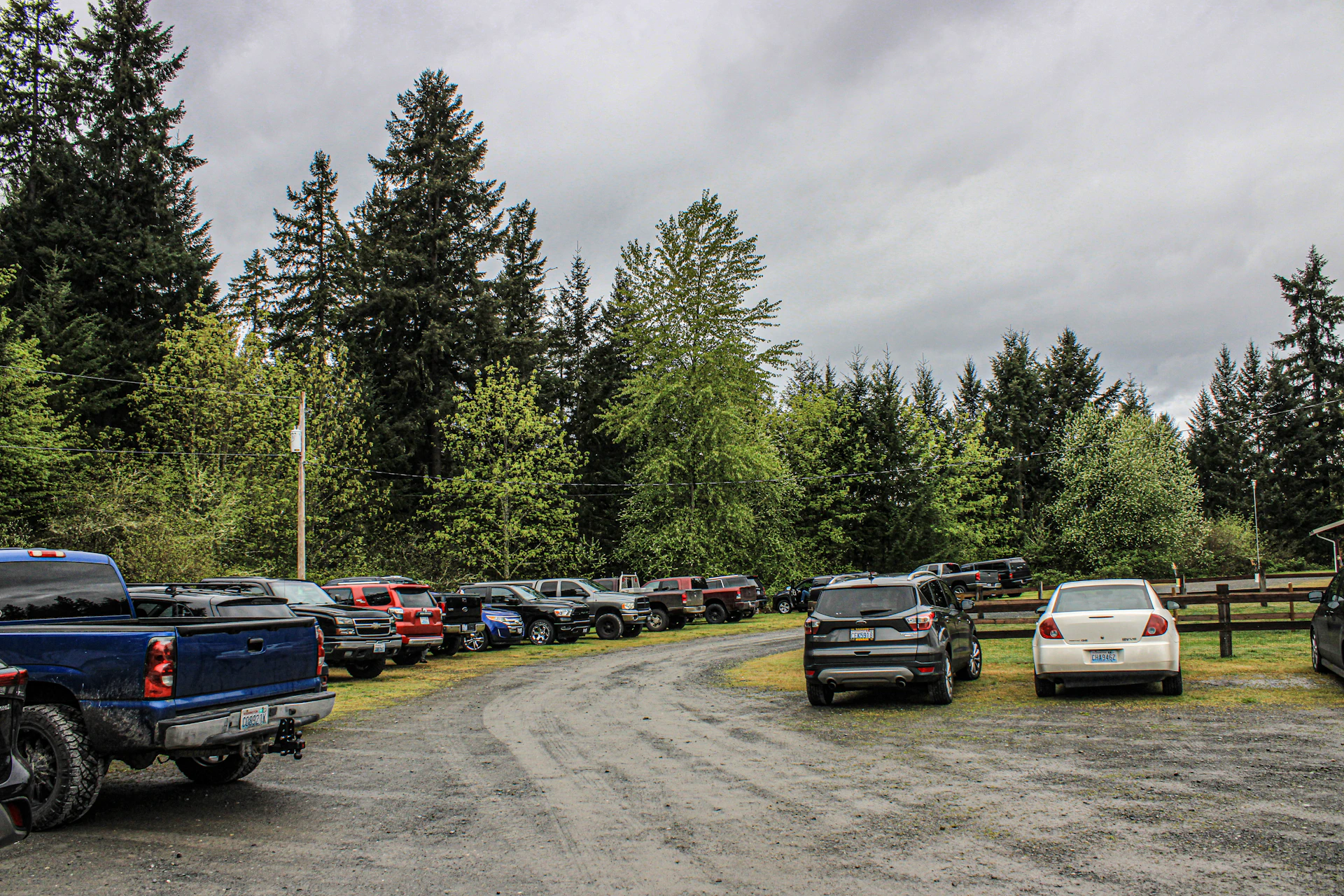 a parking lot full of cars and trucks