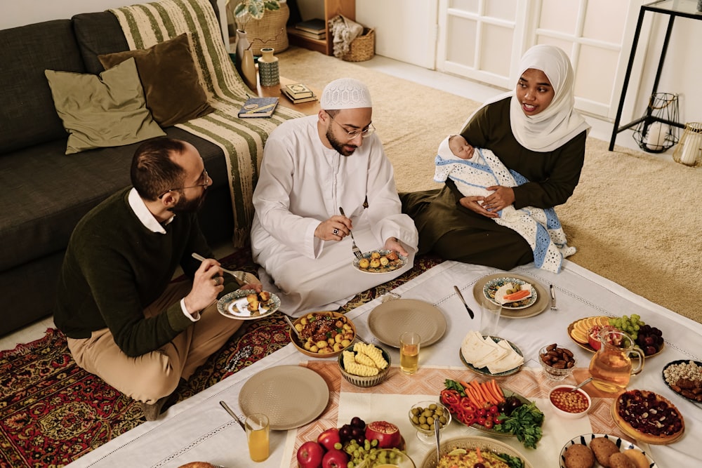 a group of people sitting on the floor eating food