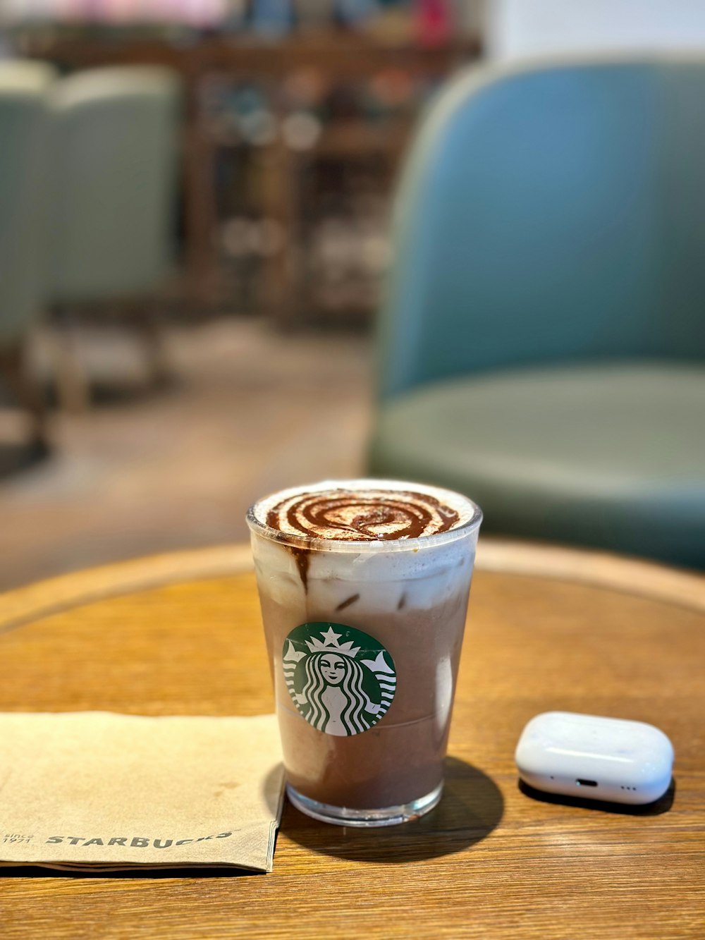 a cup of coffee sitting on top of a wooden table