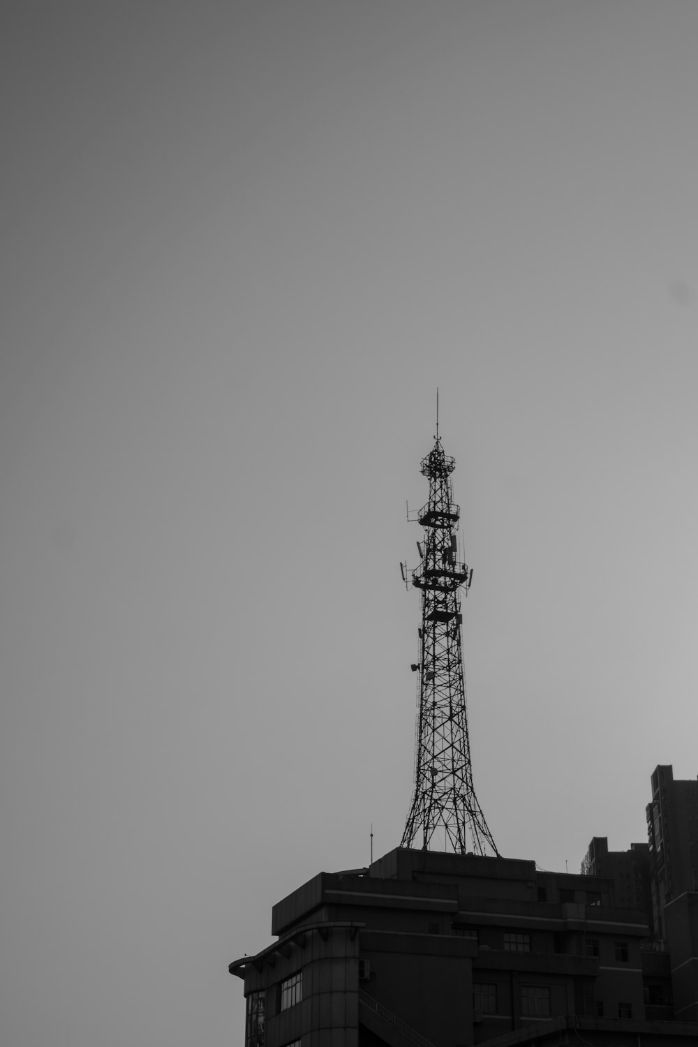 a black and white photo of a tower on top of a building