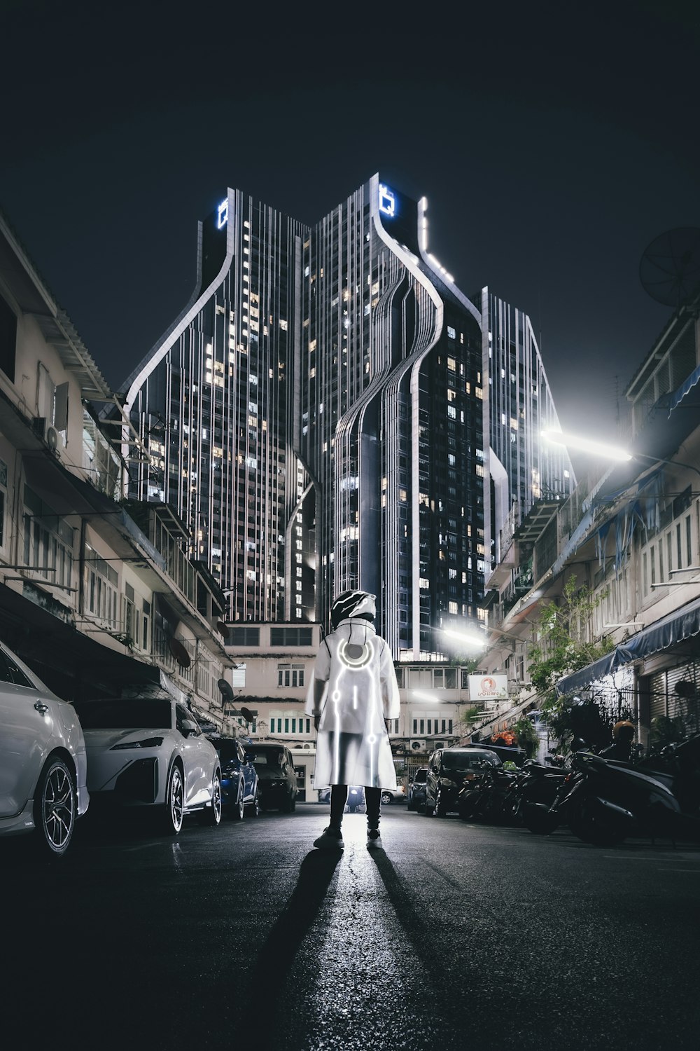 a person standing in the middle of a street at night