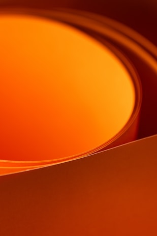 a close up of a orange bowl with a white background