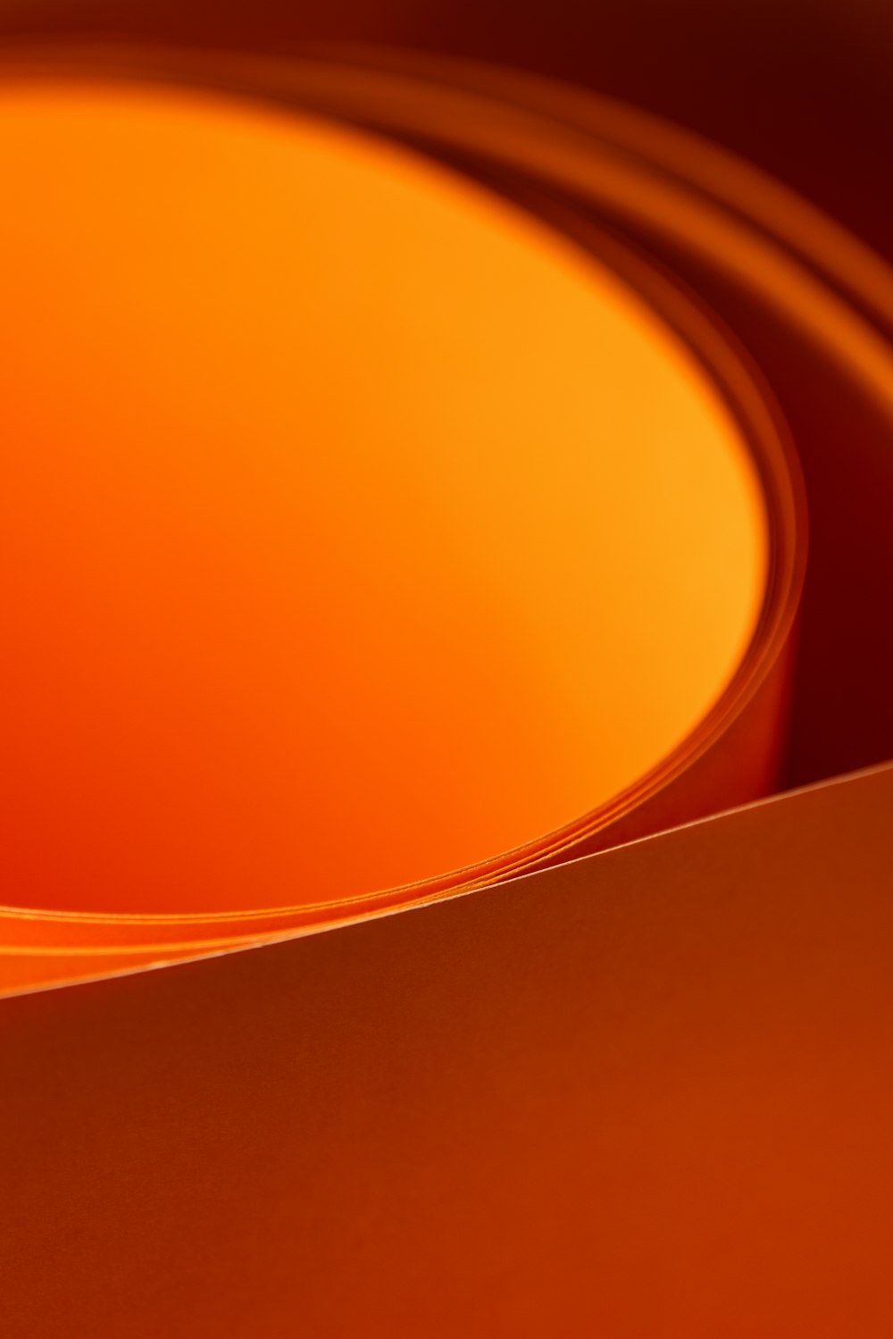 a close up of a orange bowl with a white background