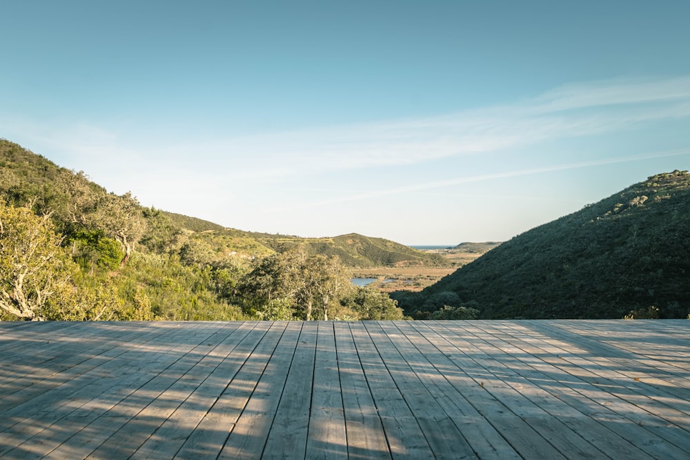 a wooden deck with a view of a valley