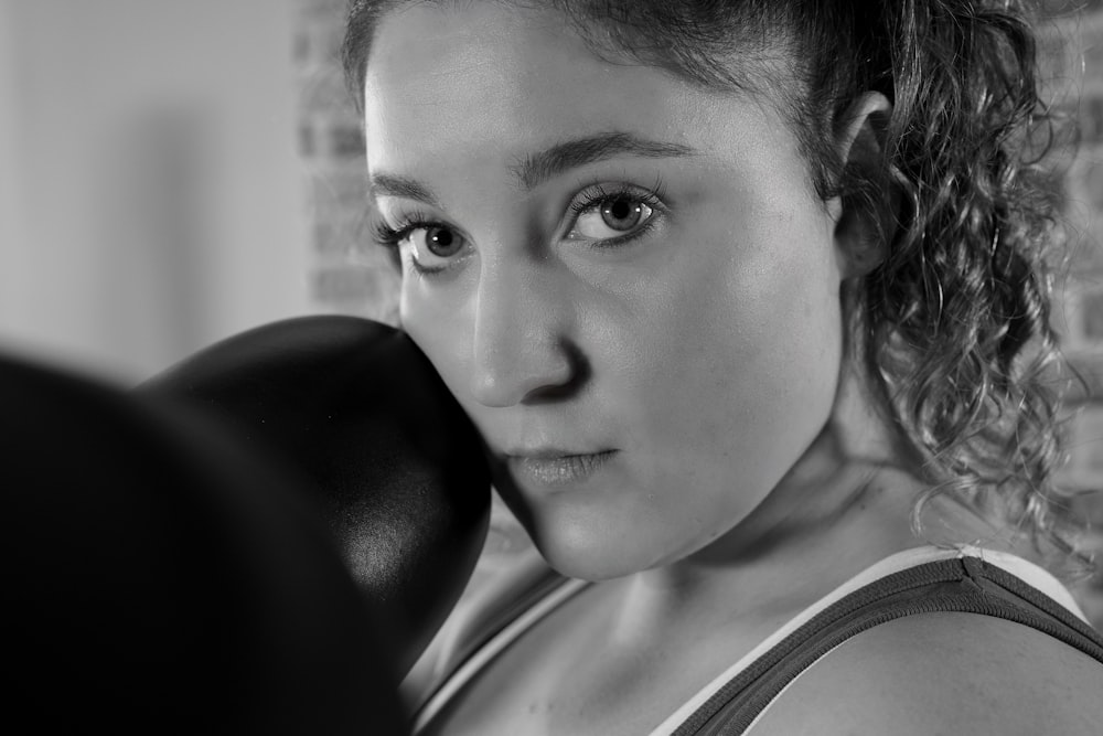 a black and white photo of a woman in a gym