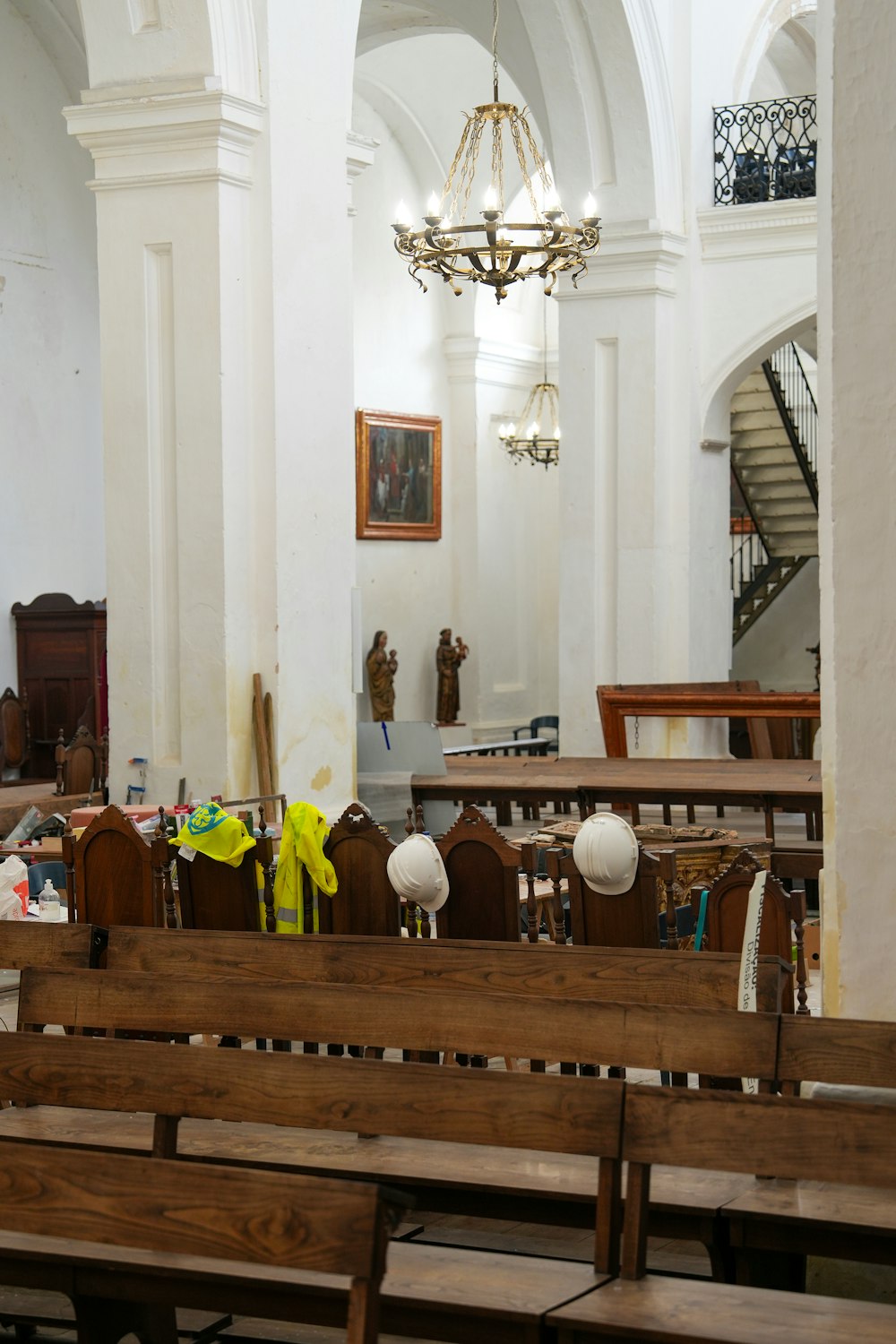 a church filled with wooden benches and a chandelier