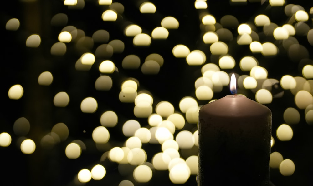 a lit candle sitting on top of a table