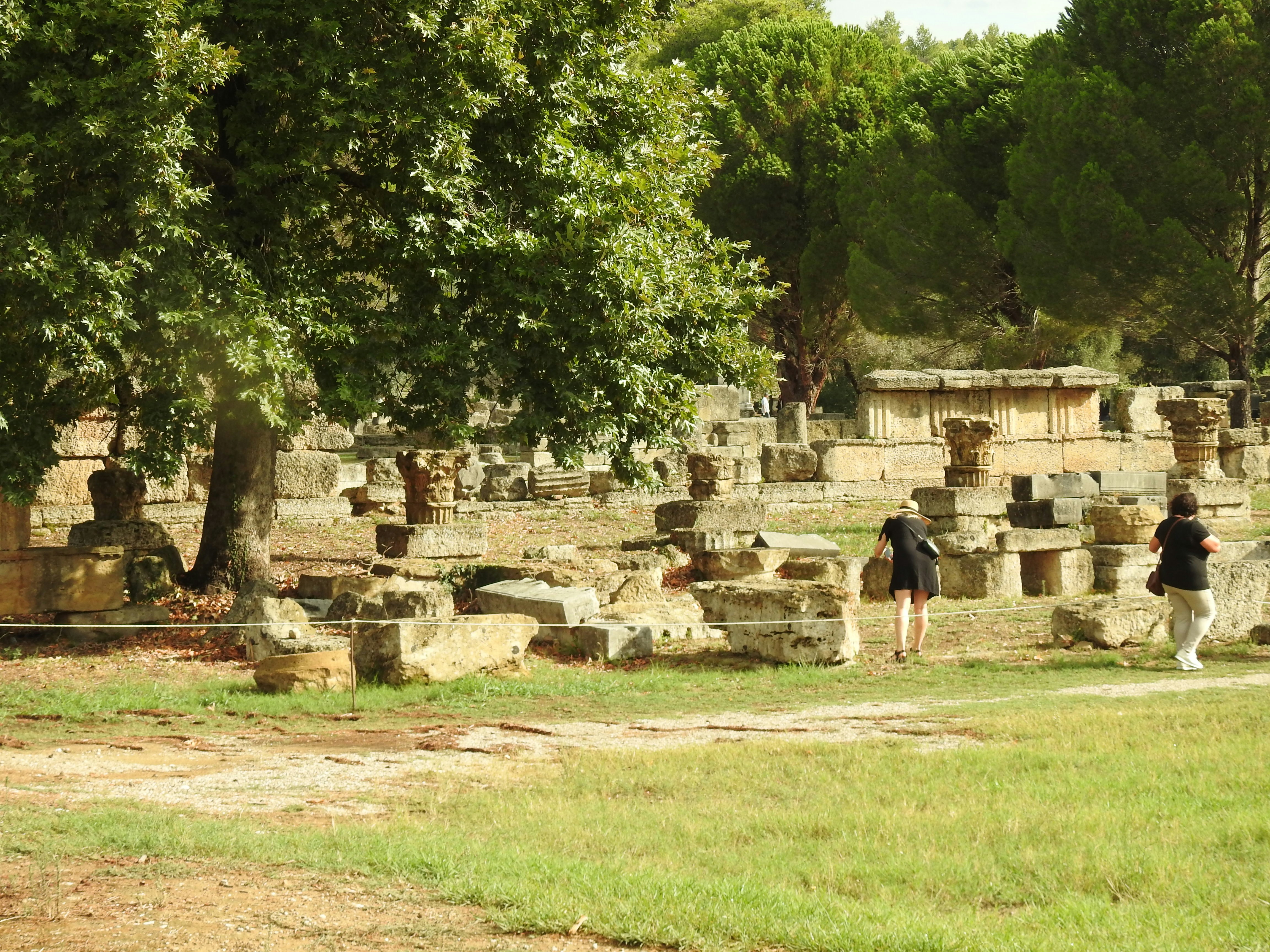 a group of people standing around a stone structure, 