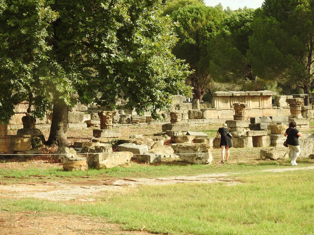 a group of people standing around a stone structure,