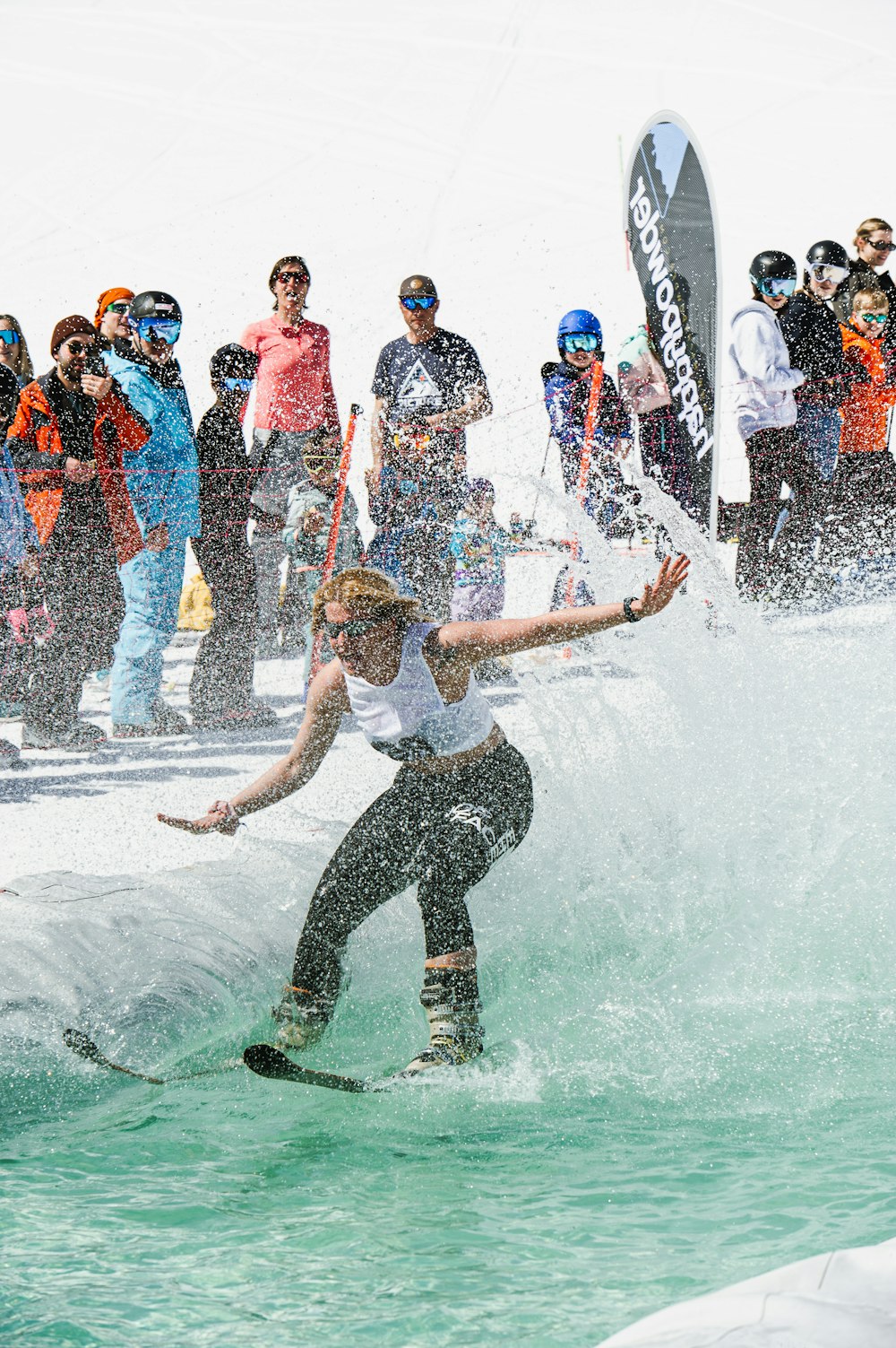 a woman riding a wave on top of a surfboard