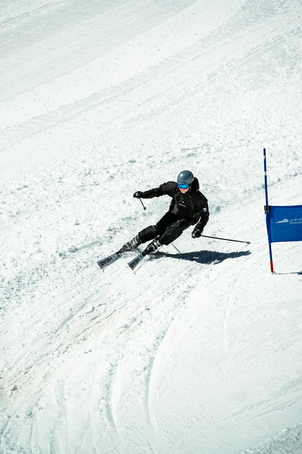 a man riding skis down a snow covered slope