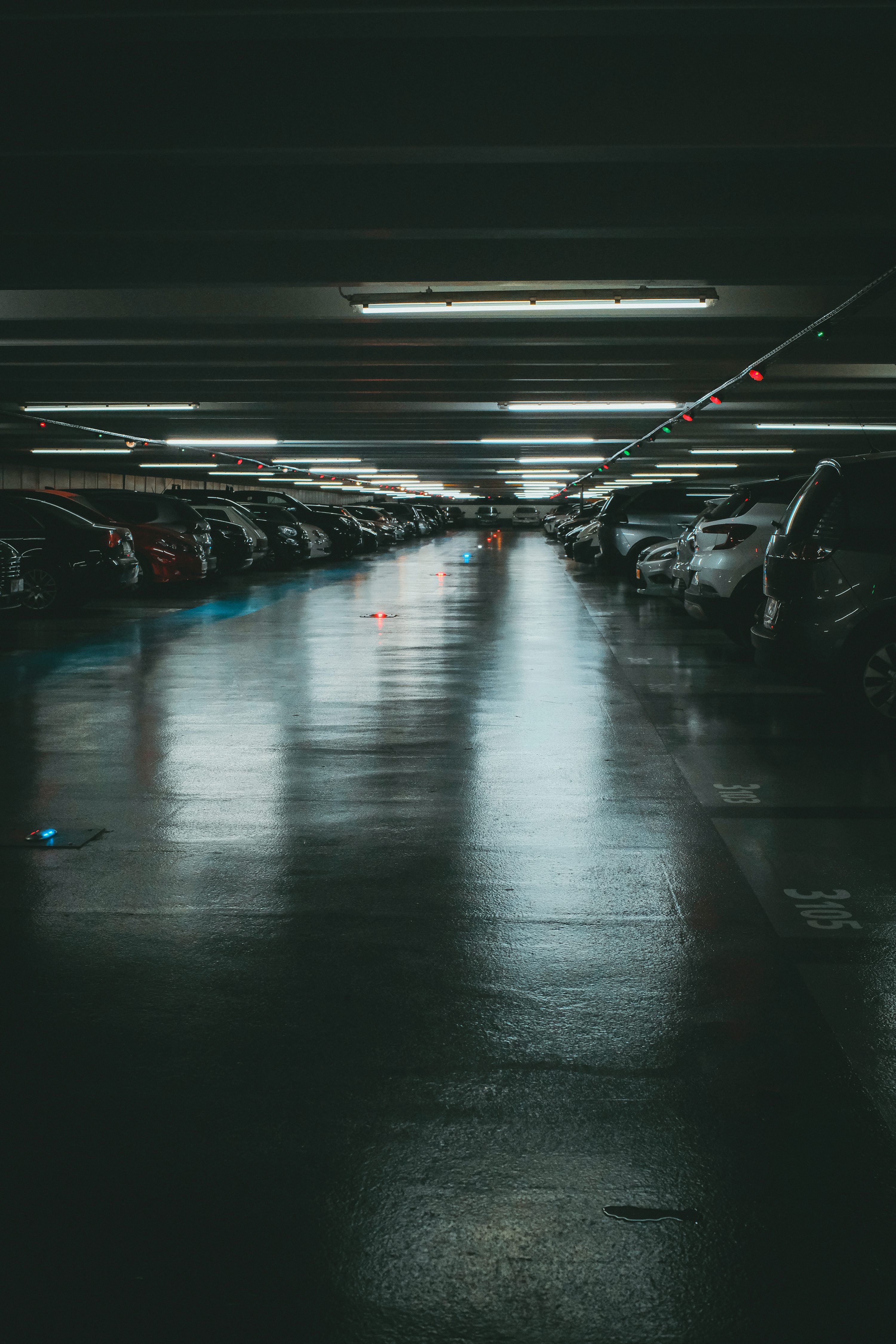 a parking garage filled with lots of parked cars