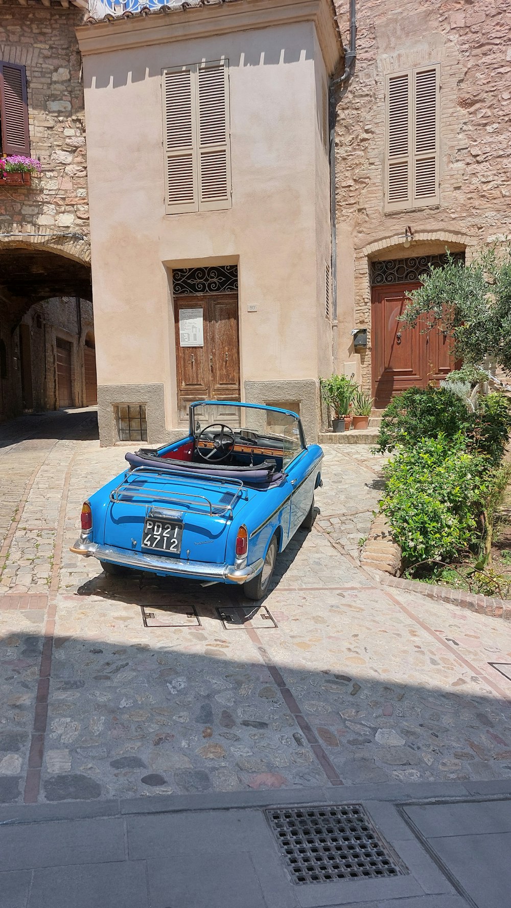 a blue car parked in front of a building