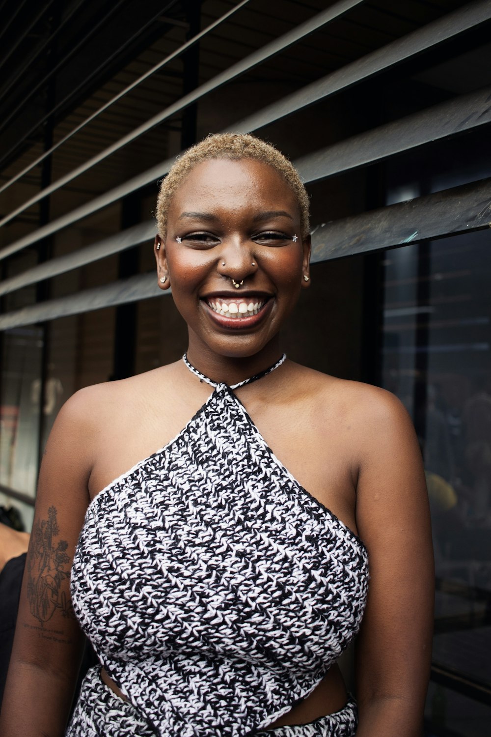 a woman in a black and white dress smiling