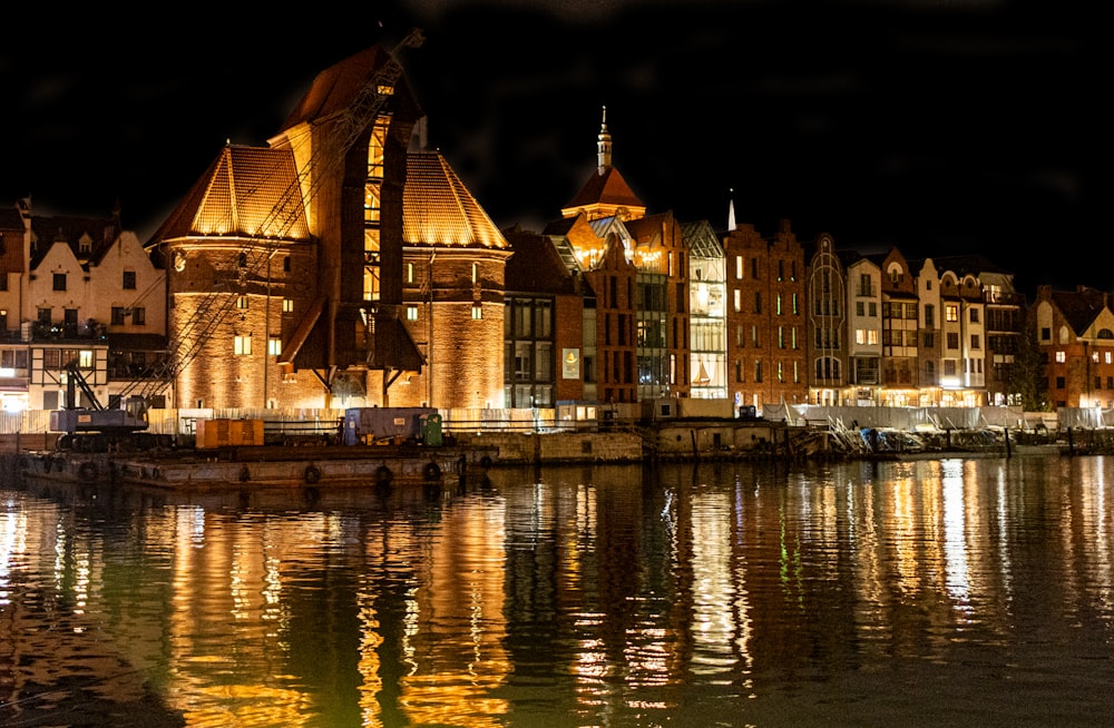 a boat is docked in a harbor at night