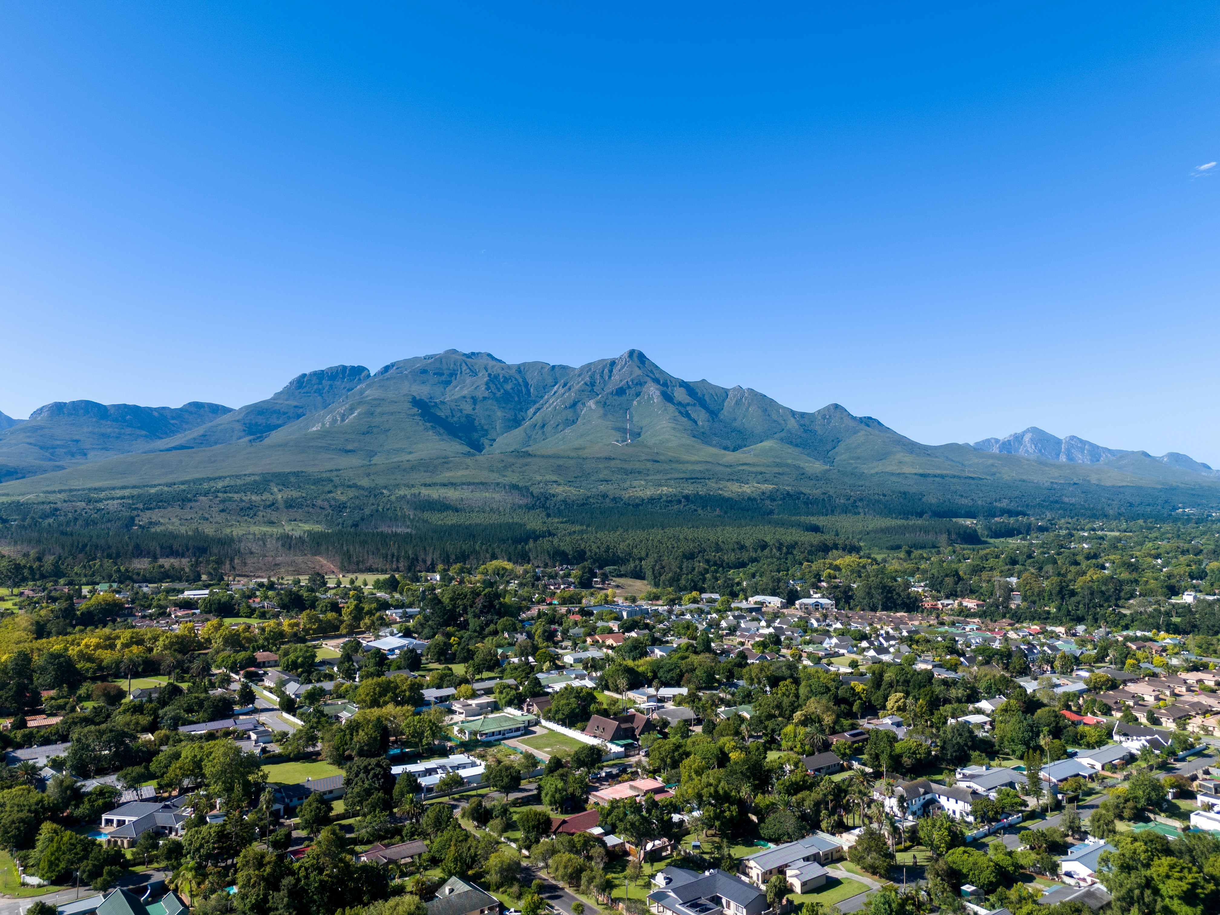 an aerial view of a city with mountains in the background