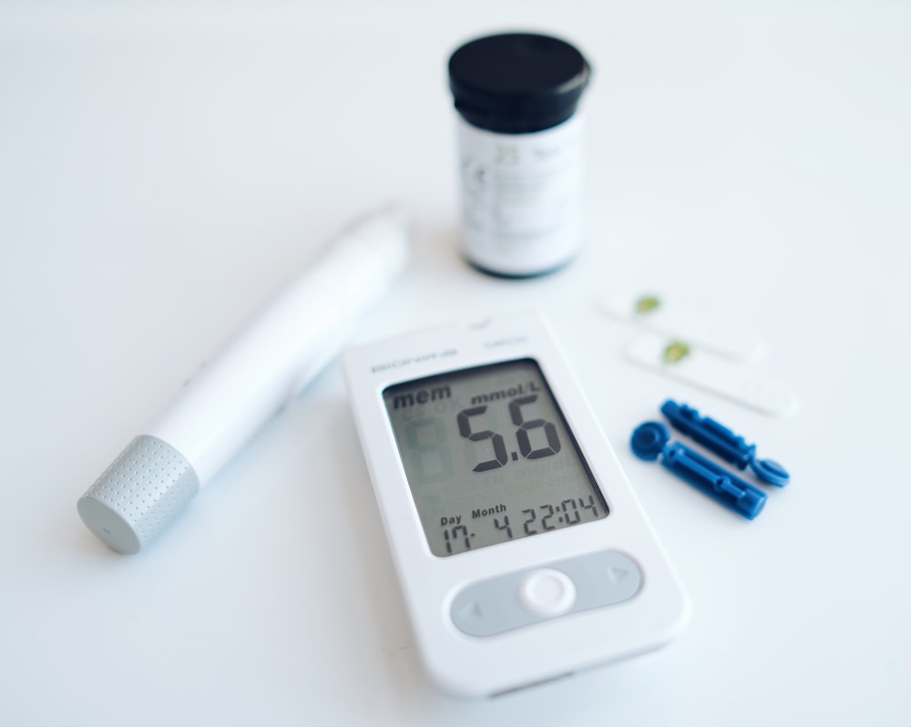 a digital thermometer sitting next to a pill bottle