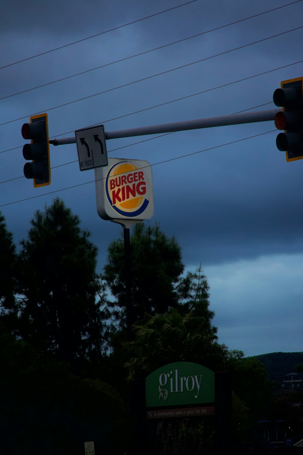 a burger king sign and traffic lights on a cloudy day