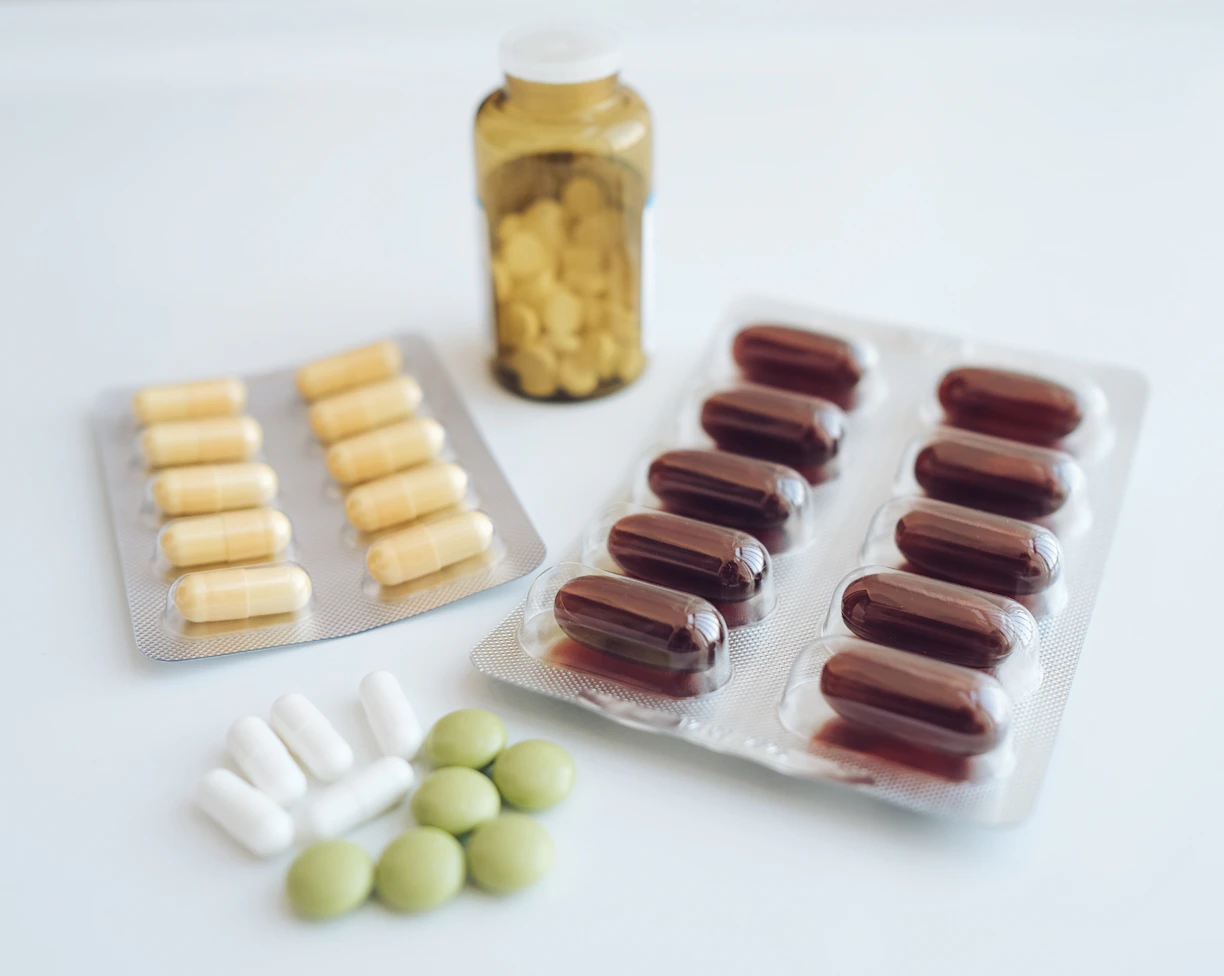 a table topped with pills and a bottle of pills
