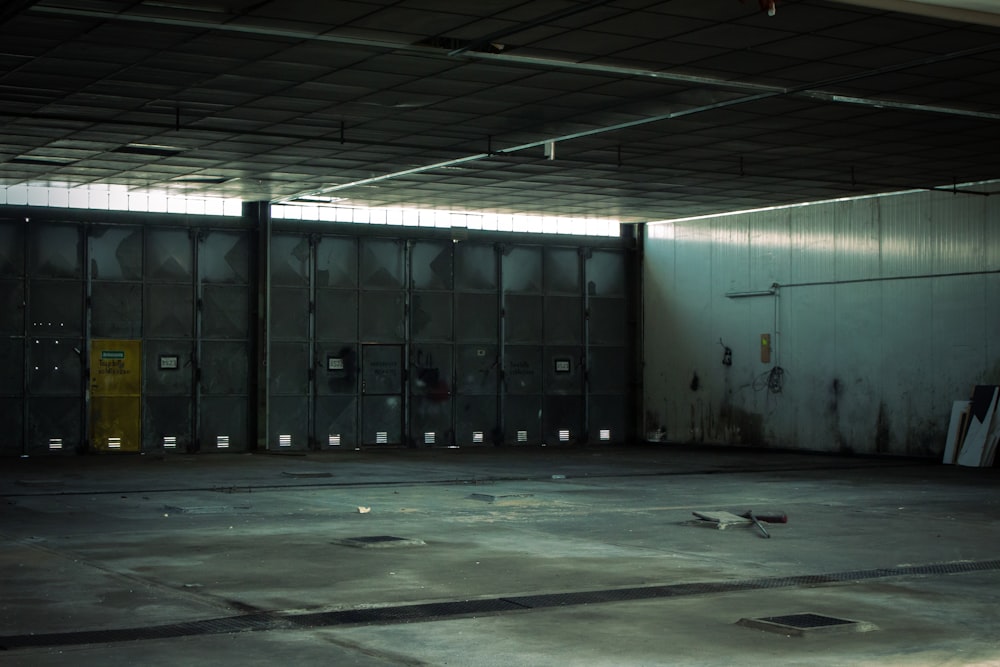 an empty parking garage with a yellow door