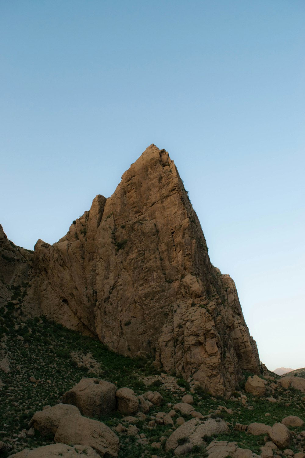 a large rock formation in the middle of a field