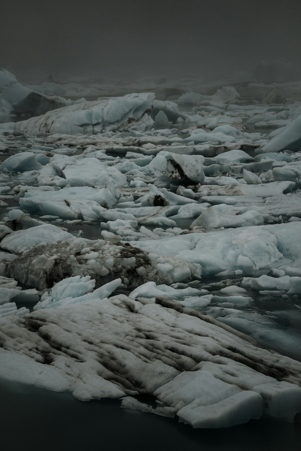 a large amount of ice floating on top of a body of water