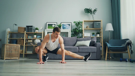 a man sitting on the floor in front of a couch