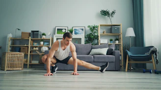 a man sitting on the floor in front of a couch