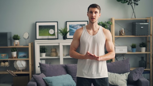 a man standing in front of a couch in a living room