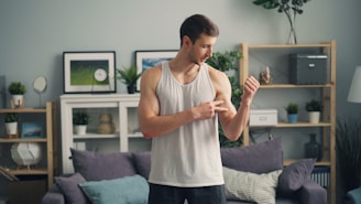 a man standing in a living room holding something in his hand