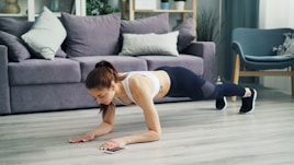 a woman is doing push ups on the floor