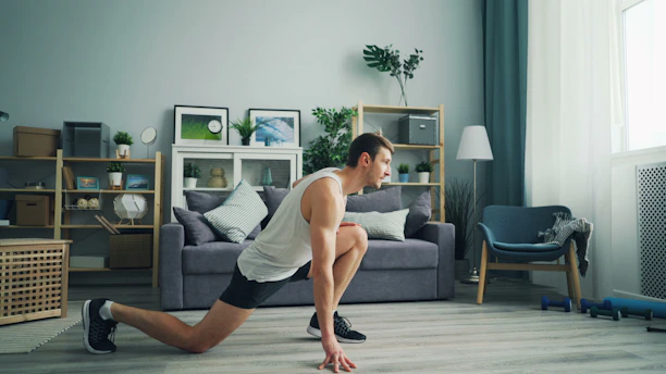 a man is doing push ups in a living room