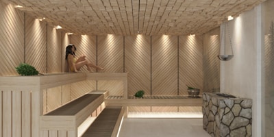 a woman sitting in a wooden sauna
