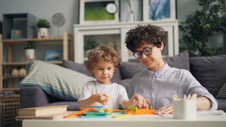 a woman and a child are sitting at a table